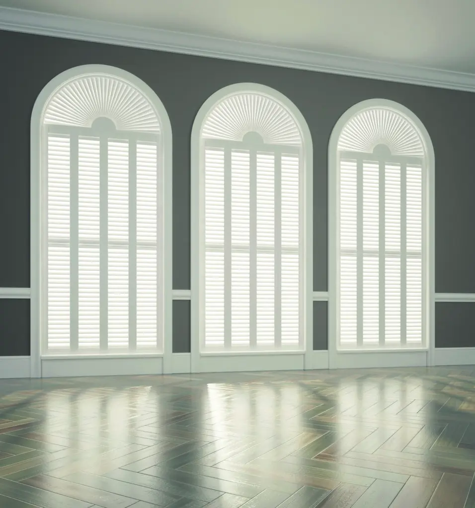 White plantation shutters on three arched windows