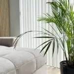White vertical blinds behind a sofa